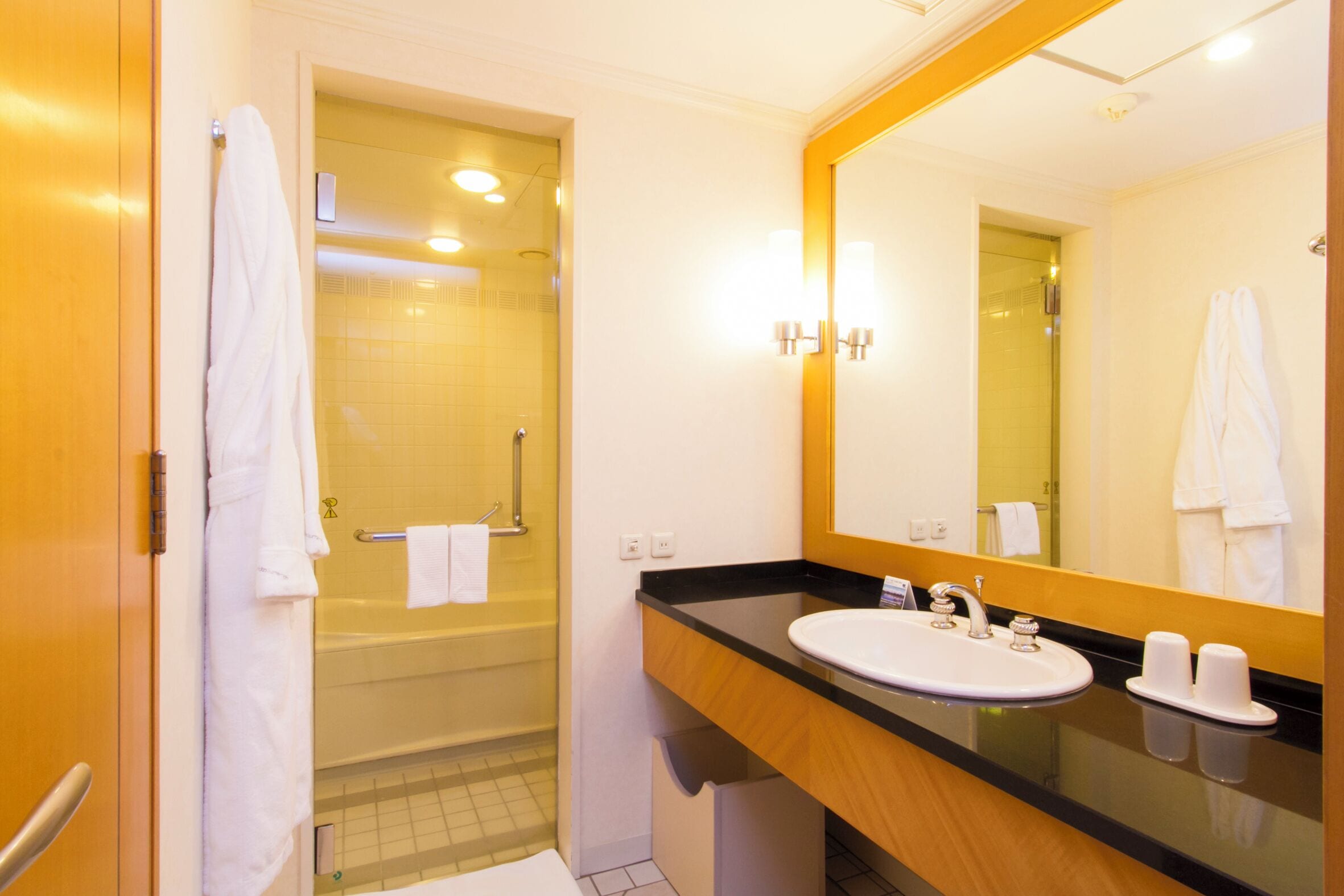 A bathroom with a bathtub, a sink, and a mirror.
