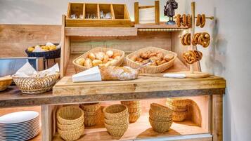 A bakery display with bread, pastries, and baskets.