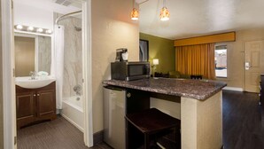 A compact kitchen with a microwave, coffee maker, and a small refrigerator. - Super 8 by Wyndham Conference Center NAU/Downtown (Flagstaff)