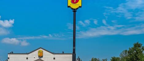 A Super 8 by Wyndham hotel with a clear blue sky.