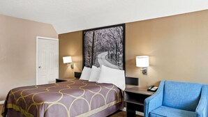 A hotel room with a bed, bedside tables, a chair, and a painting on the wall.