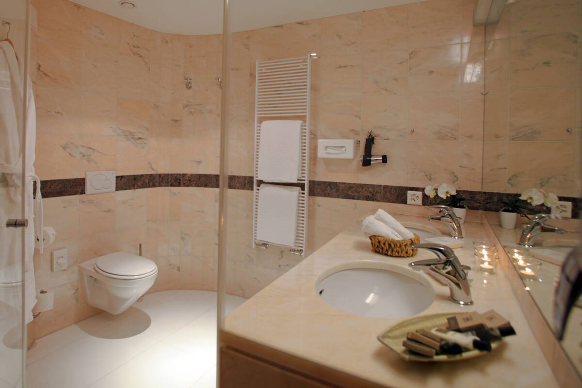 Deep soaking tub, designer toiletries, hair dryer, bathrobes