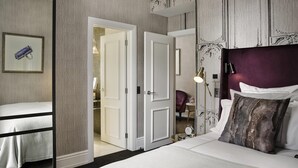 A hotel room with a bed, a bedside table, a lamp, and a wardrobe. - Fable Auckland, MGallery (Auckland)