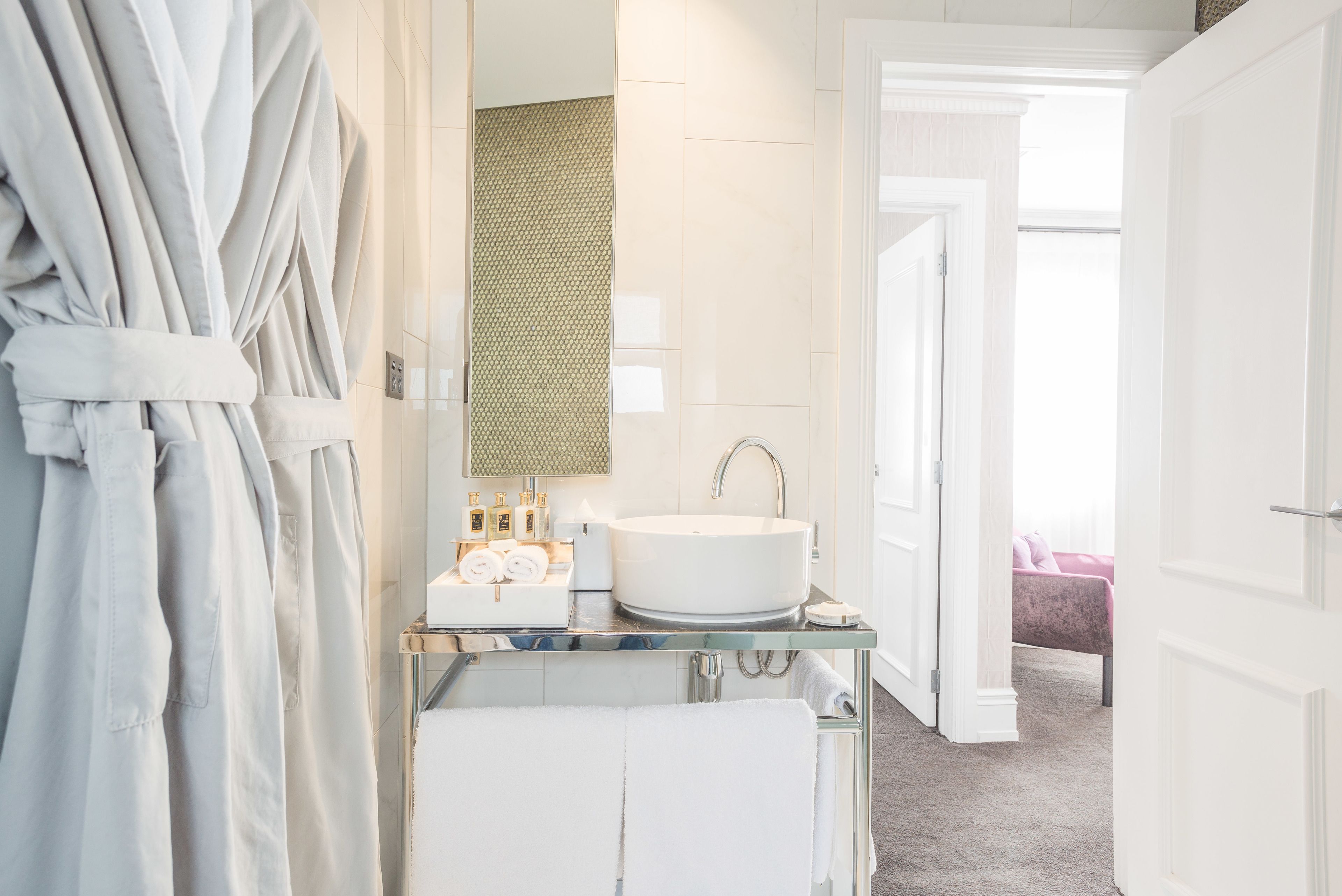 designer toiletries, hair dryer, bathrobes, slippers