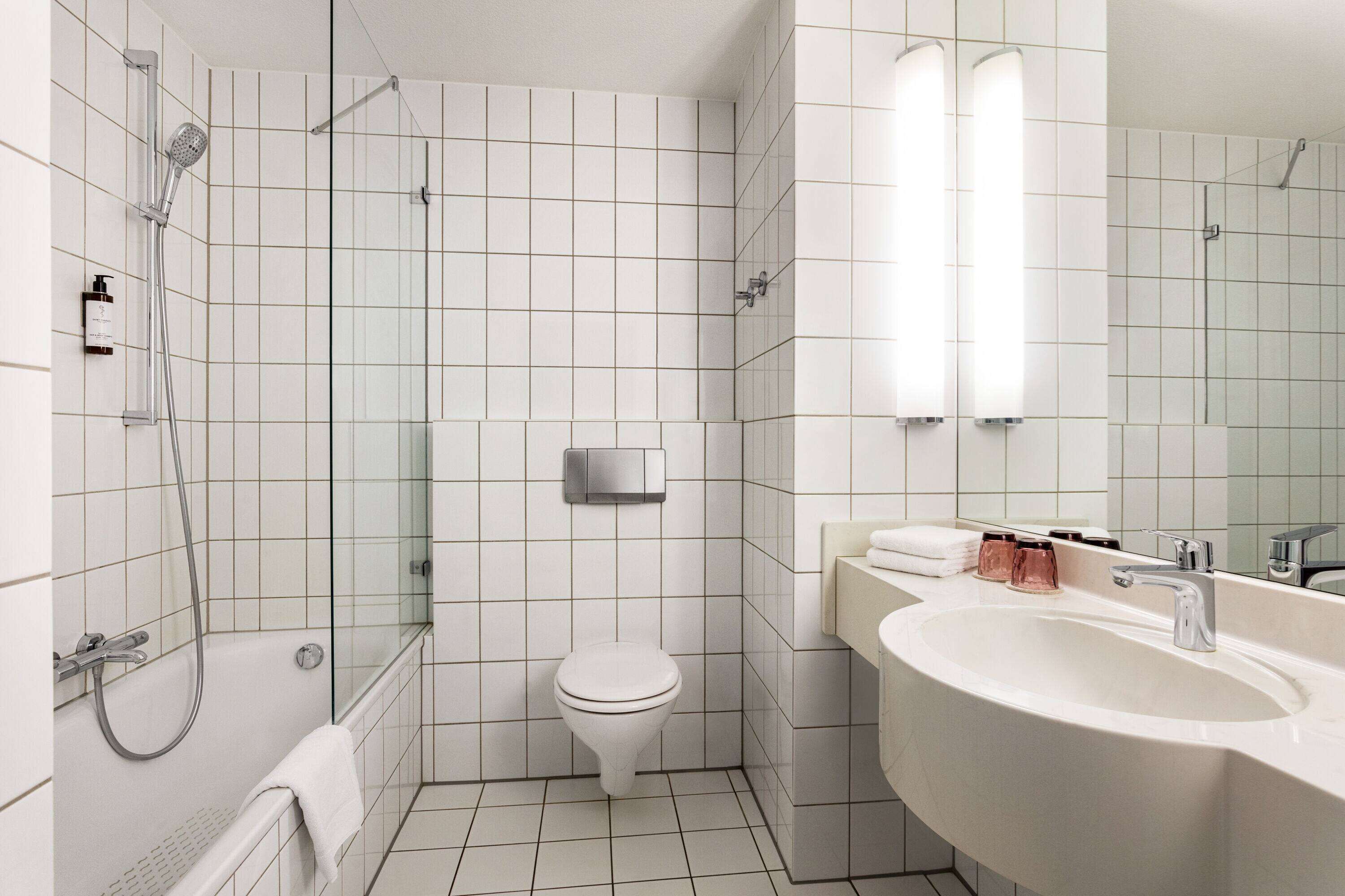 bathtub, hair dryer, towels, soap