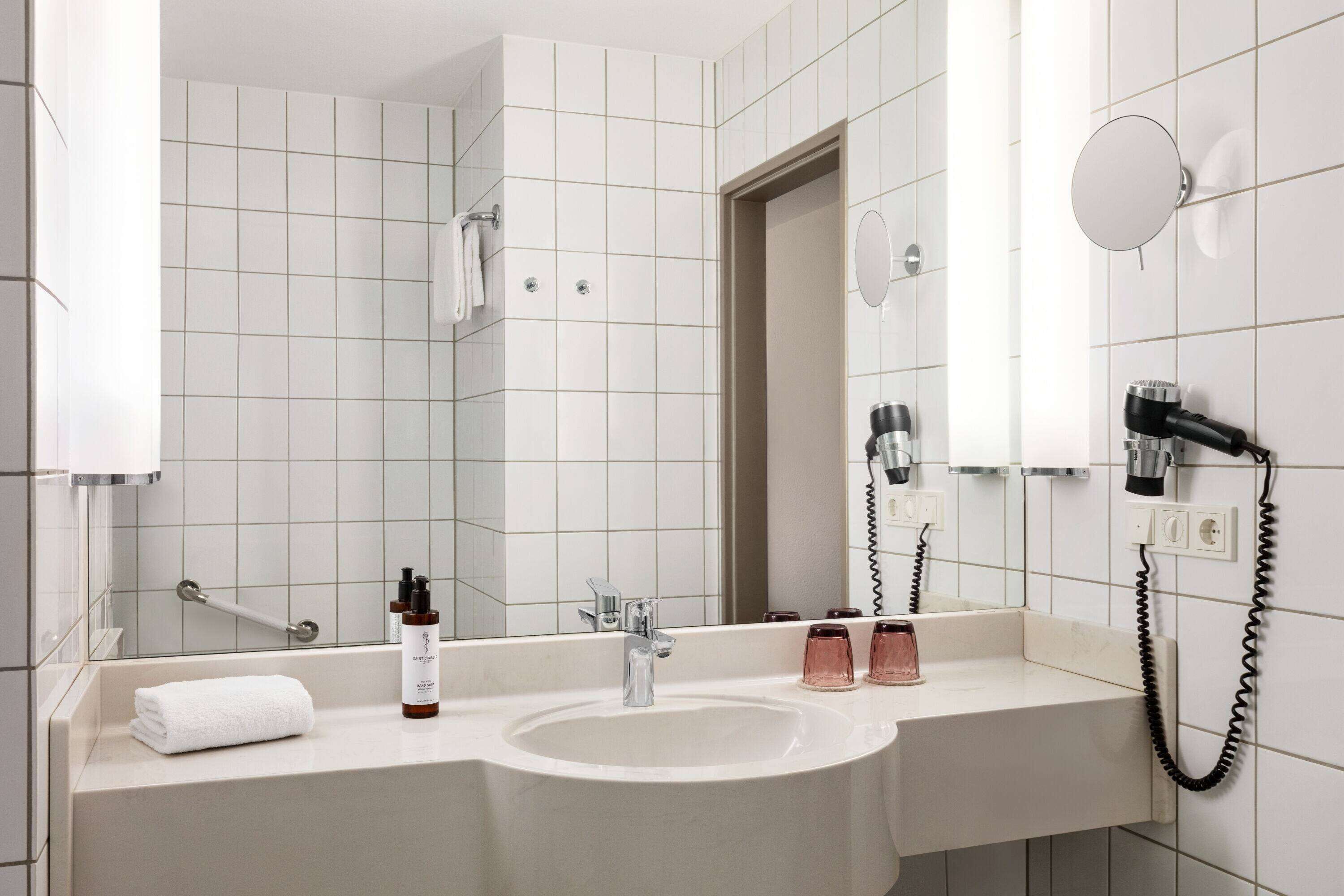 bathtub, hair dryer, towels, soap