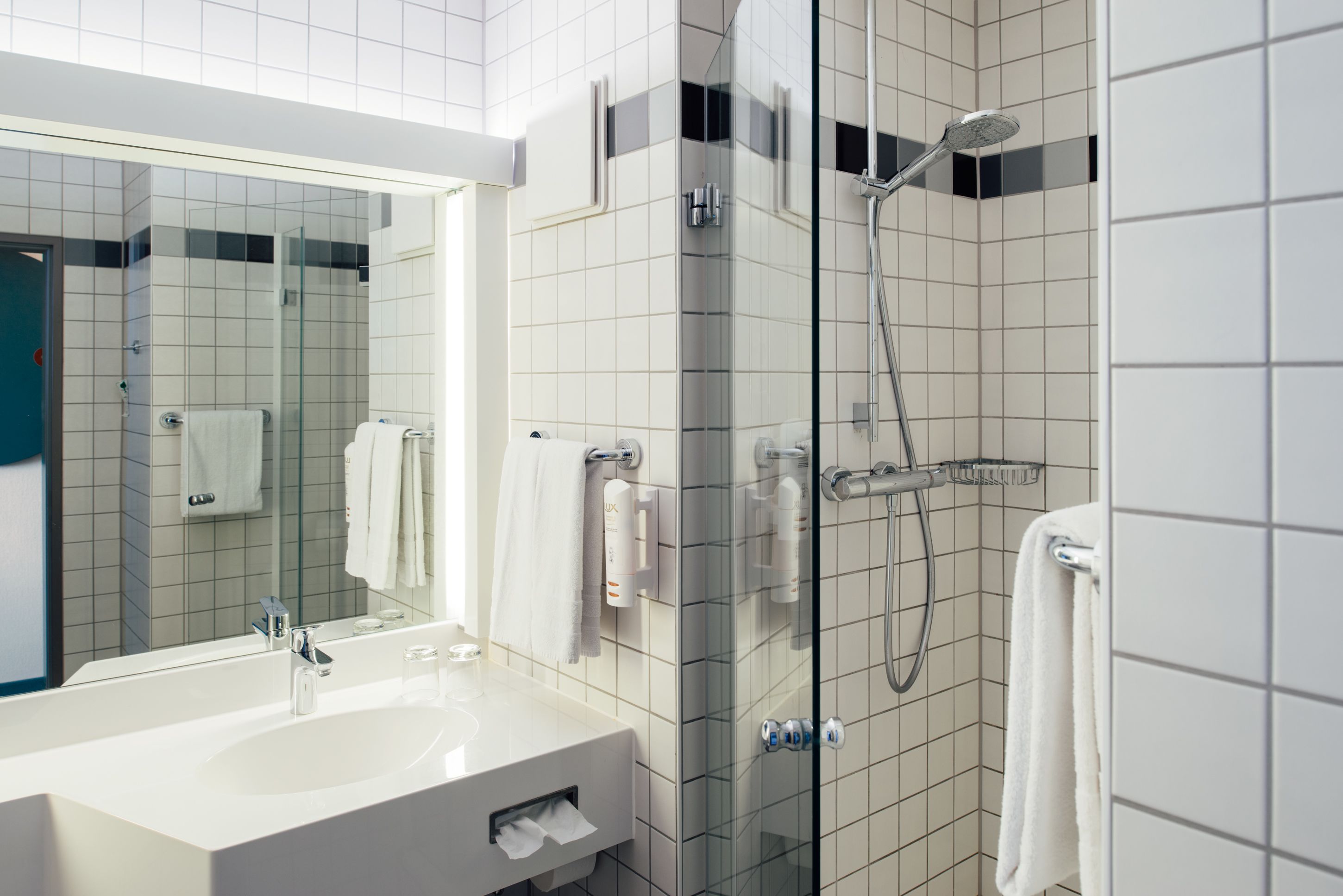 bathtub, hair dryer, towels, soap