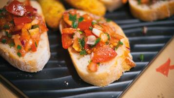 A plate with bruschetta topped with diced tomatoes and herbs.