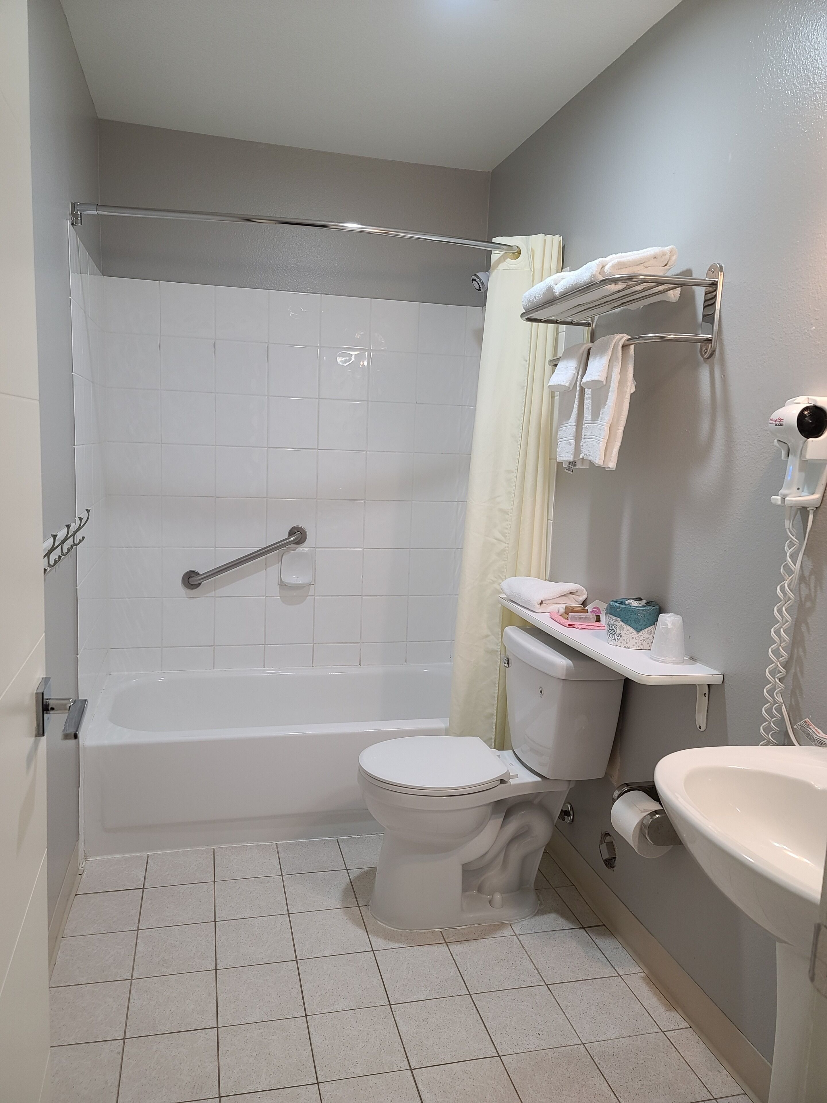 A bathroom with a bathtub, toilet, and sink.
