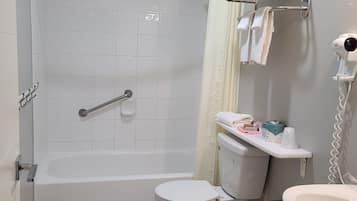 A bathroom with a bathtub, toilet, and sink.