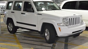 A white SUV parked in a multi-level parking garage. - Castle Inn (San Francisco)