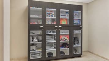 A kitchen with a built-in refrigerator, oven, and microwave.