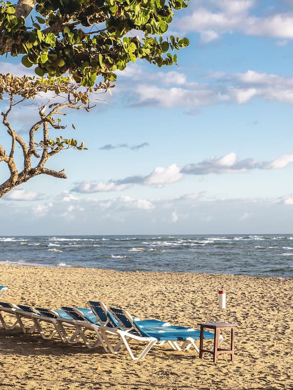 On the beach, white sand, sun loungers, beach umbrellas