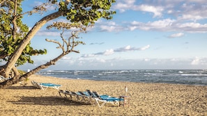 On the beach, white sand, sun-loungers, beach umbrellas