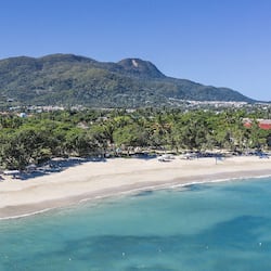 On the beach, white sand, sun loungers, beach umbrellas