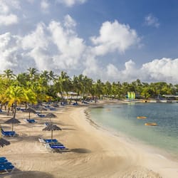 On the beach, white sand, sun loungers, beach umbrellas