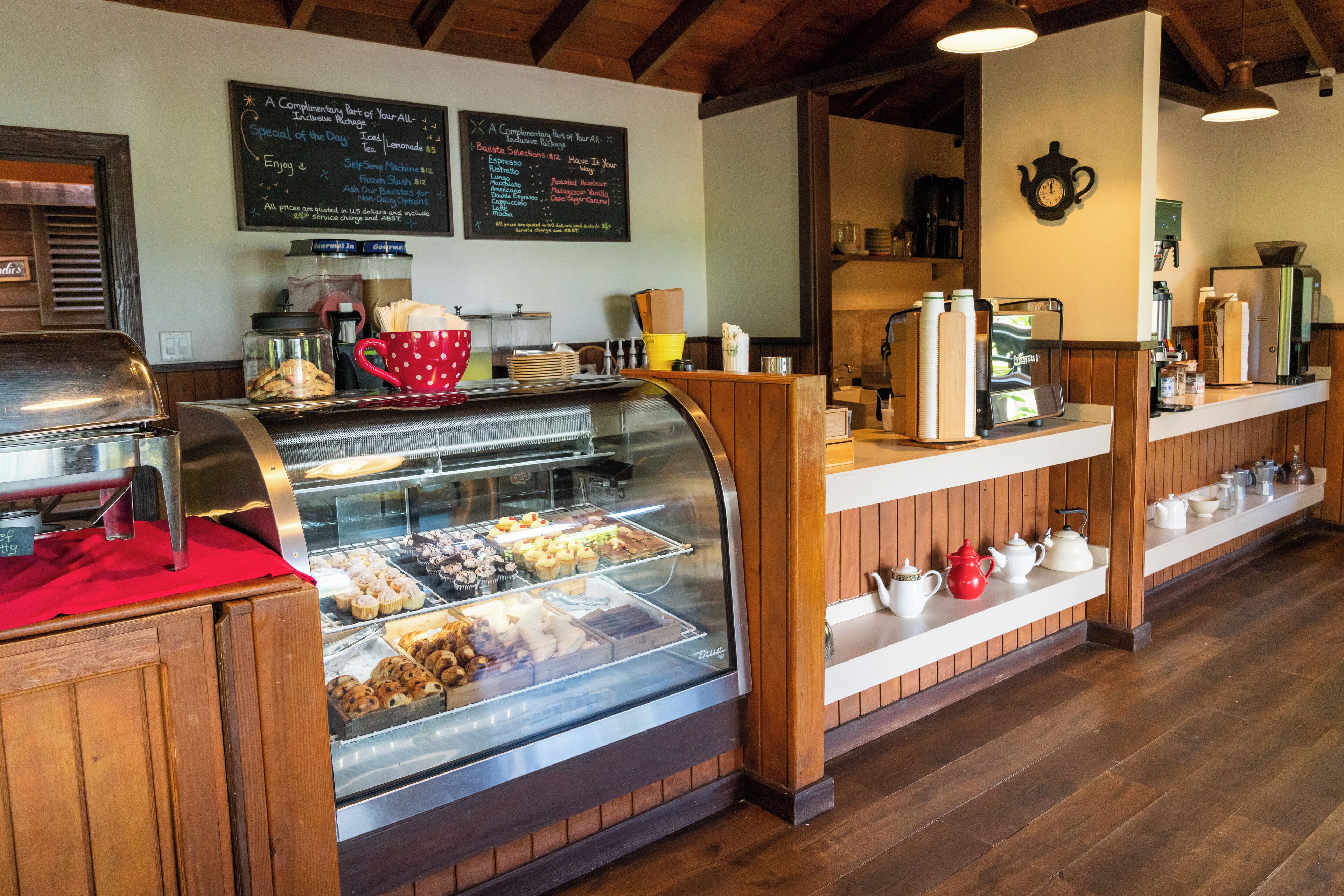 A bakery display case with pastries and a coffee machine.