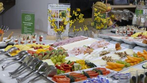 A buffet with various food items and utensils. - Petit Palace Arana (Bilbao)