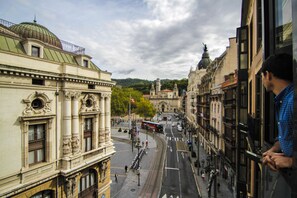 A street view with historic buildings, a tram, and a clear sky. - Petit Palace Arana (Bilbao)