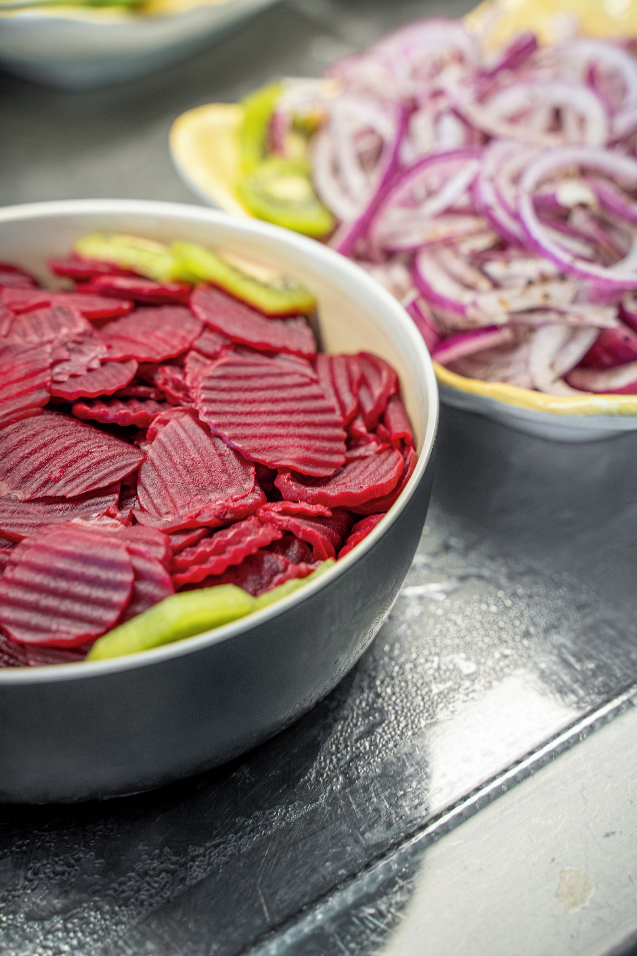 A close-up of a bowl containing sliced beets.