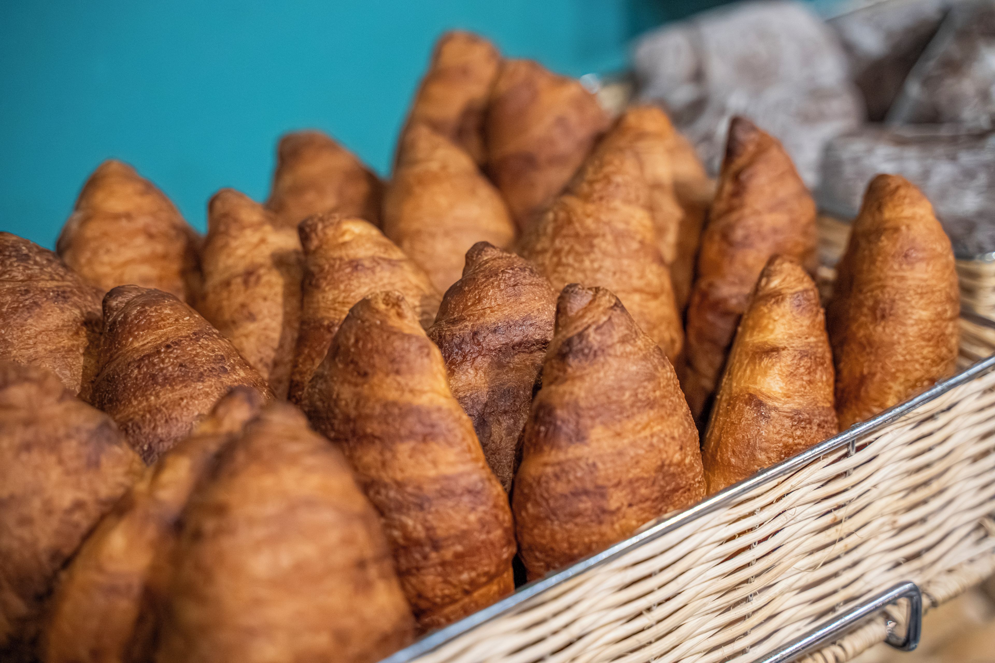 A basket filled with croissants.