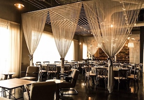 A restaurant with a modern interior, featuring tables and chairs arranged in a spacious layout.