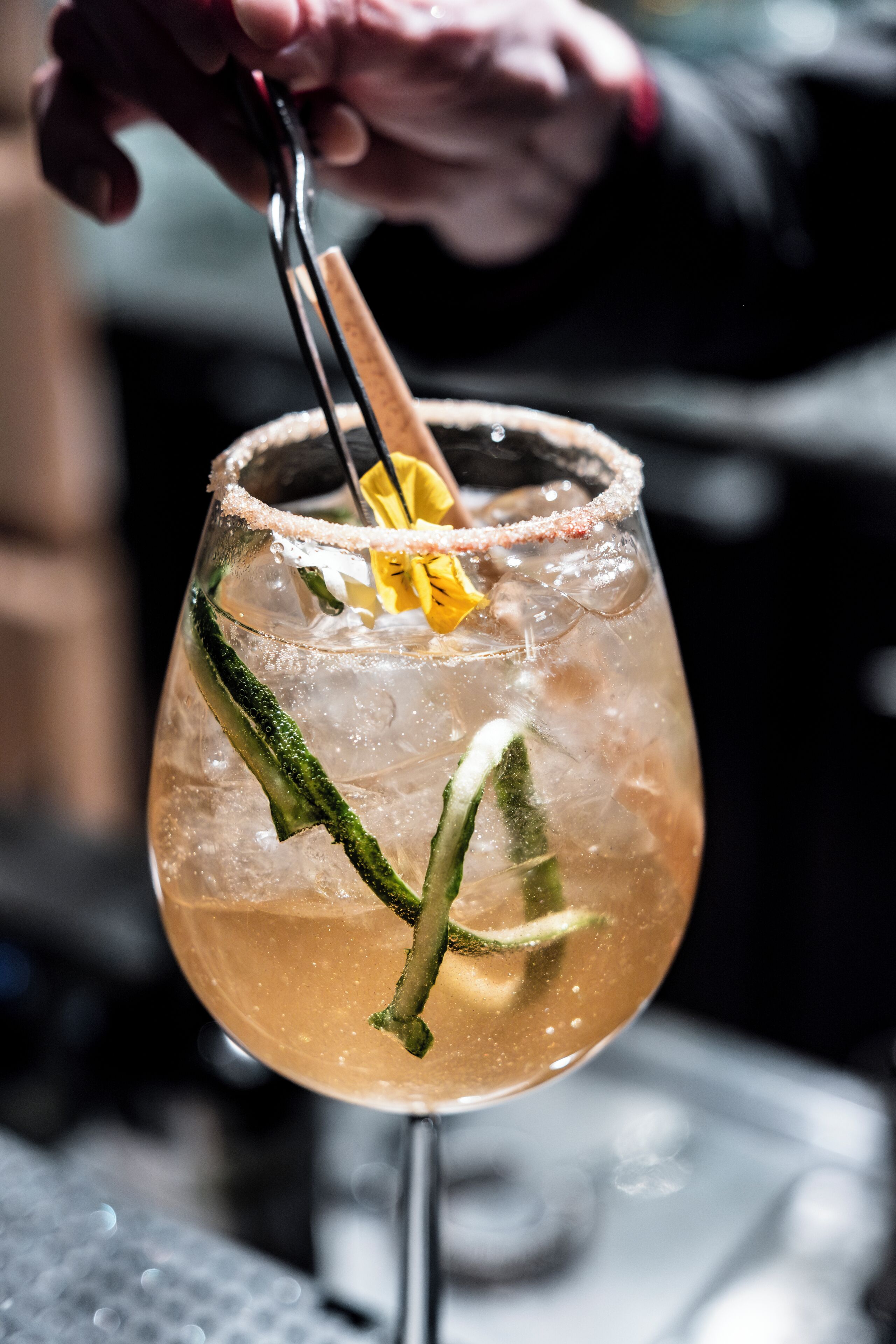 En cocktail med en saltad kant och garnering, serverad i ett vinglas.