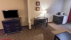 A hotel room with a flat-screen TV, a desk with a chair, a lamp, a microwave, and a small cabinet. - Comfort Inn Pittsburgh Crafton (Pittsburgh)