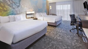 A hotel room with two beds, a desk, a chair, a TV, and a large abstract mural on the wall. - Courtyard Somerset by Marriott (Somerset)