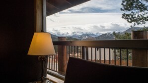 A room with a view of snow-capped mountains through a window. - Hotel Estes (Estes Park)