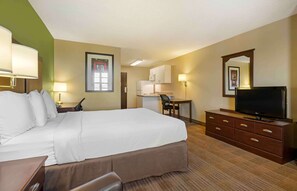 A hotel room with a large bed, a desk, a chair, a television, and a kitchenette. - Extended Stay America Suites Reno South Meadows (Reno)