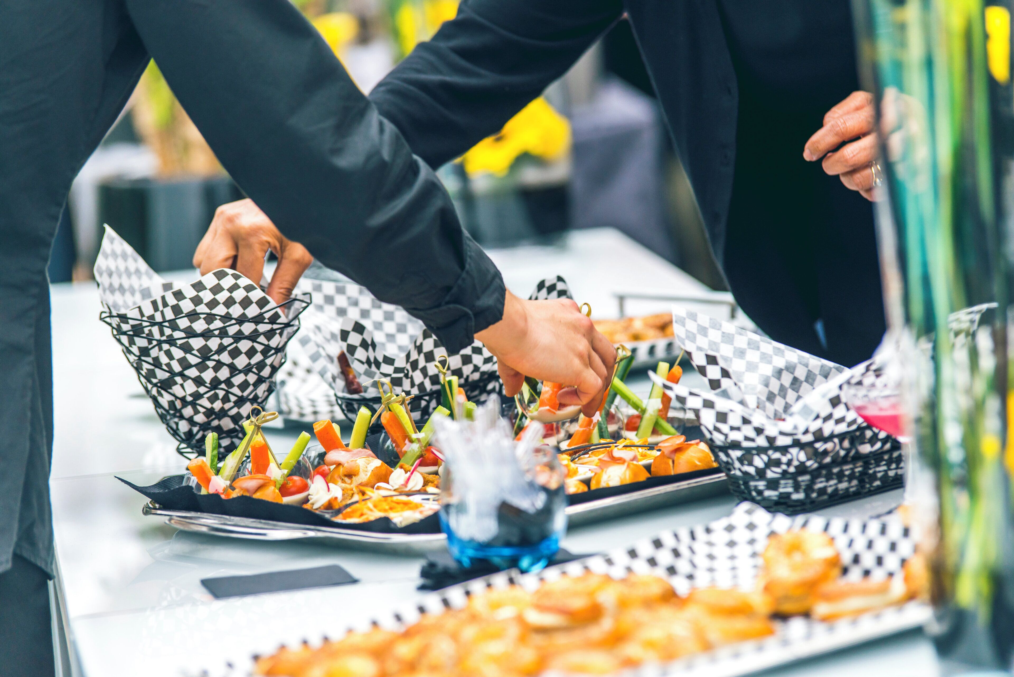 A buffet table with various food items and serving utensils.