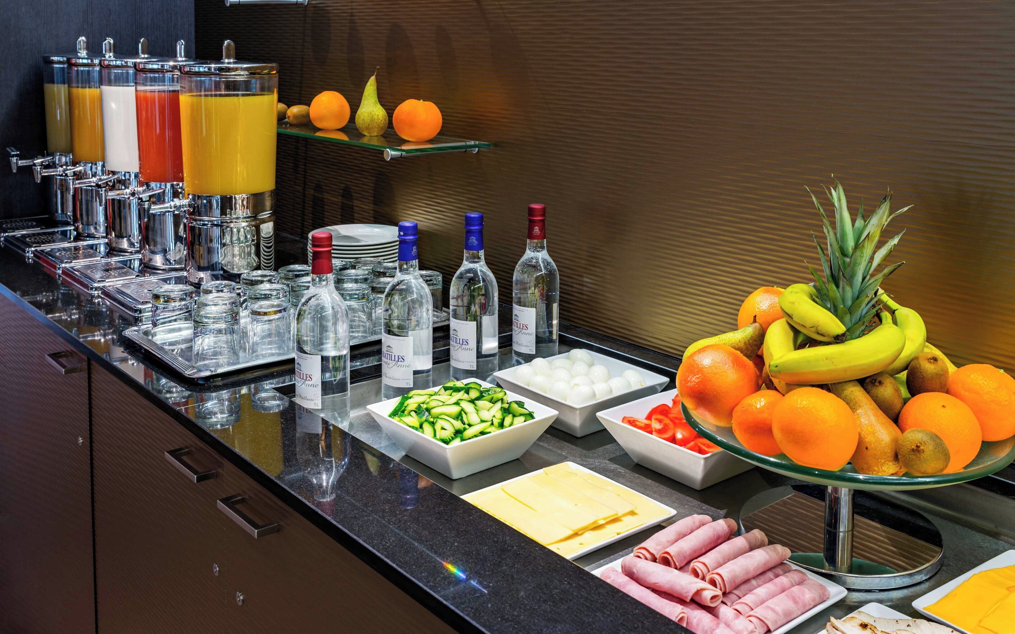 A buffet setup with various food items and beverages.