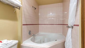 A bathroom with a bathtub, a shower, and a toilet.