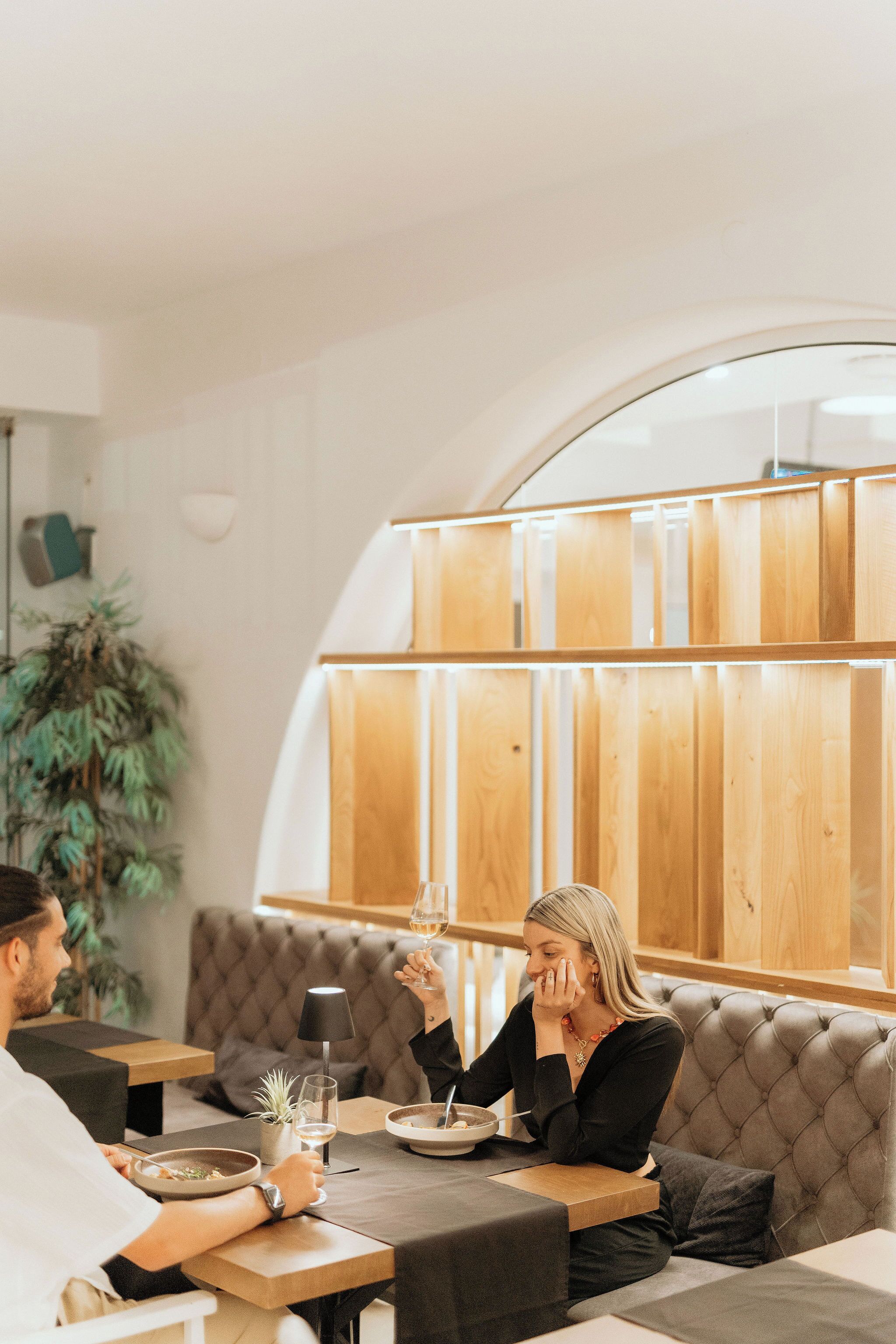 Un comedor con una mesa, sillas, un sofá y una planta en maceta.