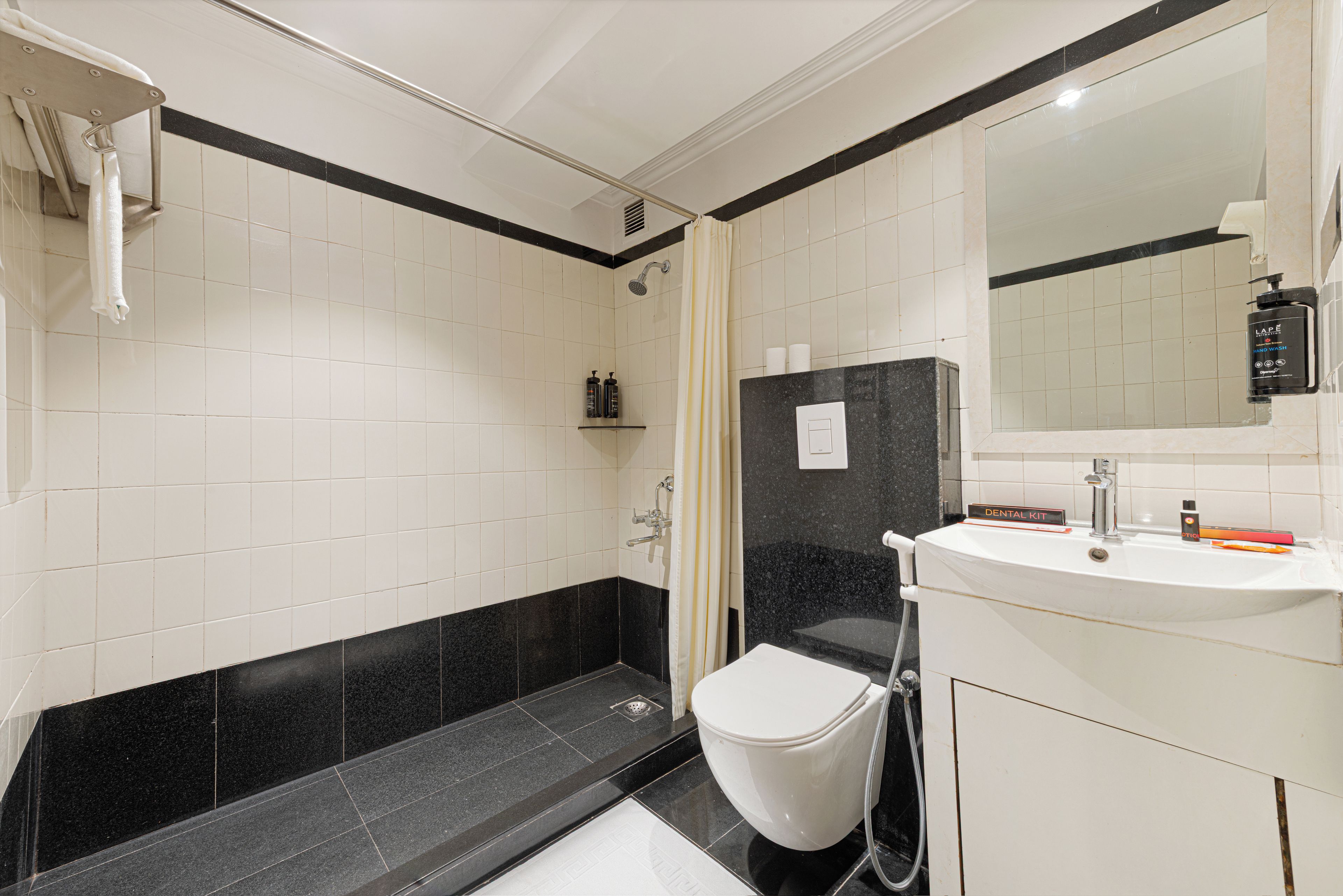 A modern bathroom with a shower, toilet, and sink.