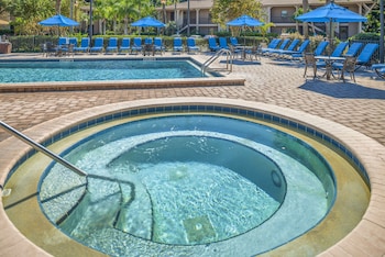 Outdoor pool, sun loungers at Hilton Vacation Club Polynesian Isles Kissimmee