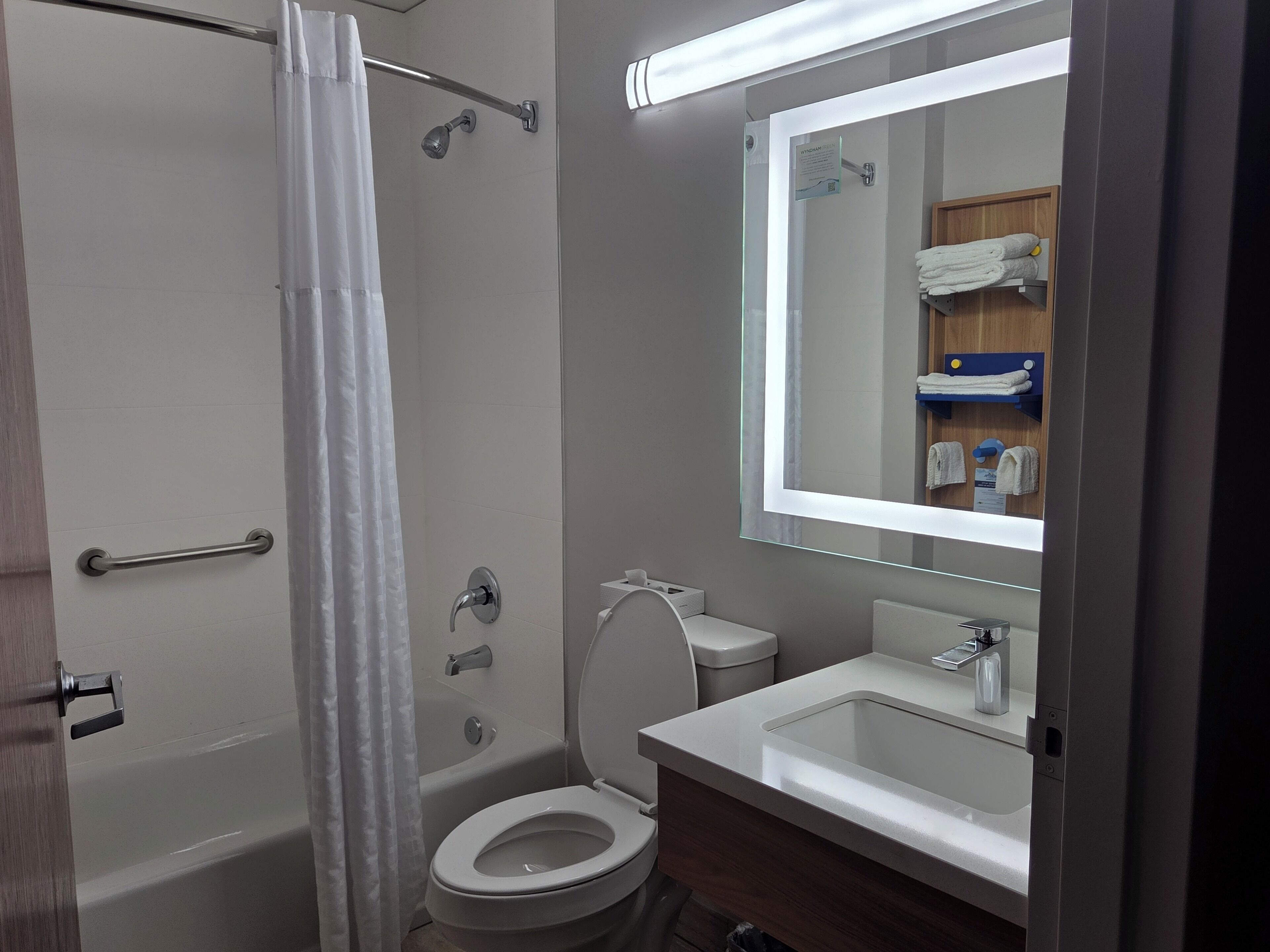 A bathroom with a bathtub, toilet, and sink.