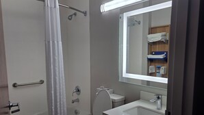 A bathroom with a bathtub, toilet, and sink.