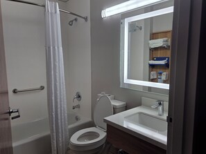 A bathroom with a bathtub, toilet, and sink. - Microtel Inn & Suites by Wyndham Hagerstown by I-81 (Hagerstown)