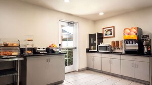 A modern kitchen with a coffee station, a microwave, and a toaster. - Microtel Inn & Suites by Wyndham Lodi/North Stockton (Lodi)