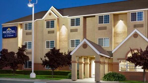 A Microtel by Wyndham hotel with a modern facade, multiple windows, and a well-lit entrance. - Microtel Inn & Suites by Wyndham Lodi/North Stockton (Lodi)
