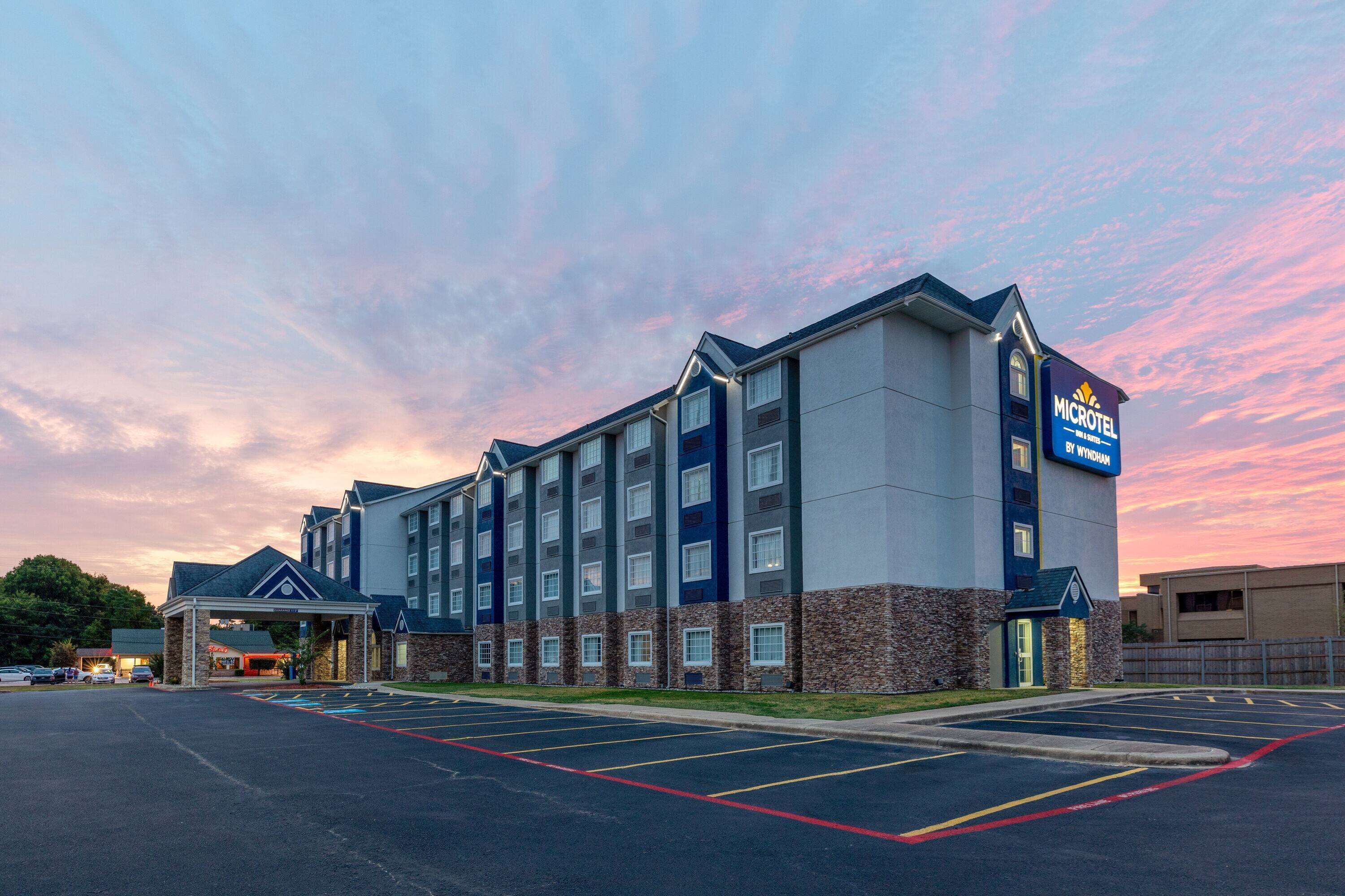 A Microtel by Wyndham hotel with a parking lot and a covered entrance.