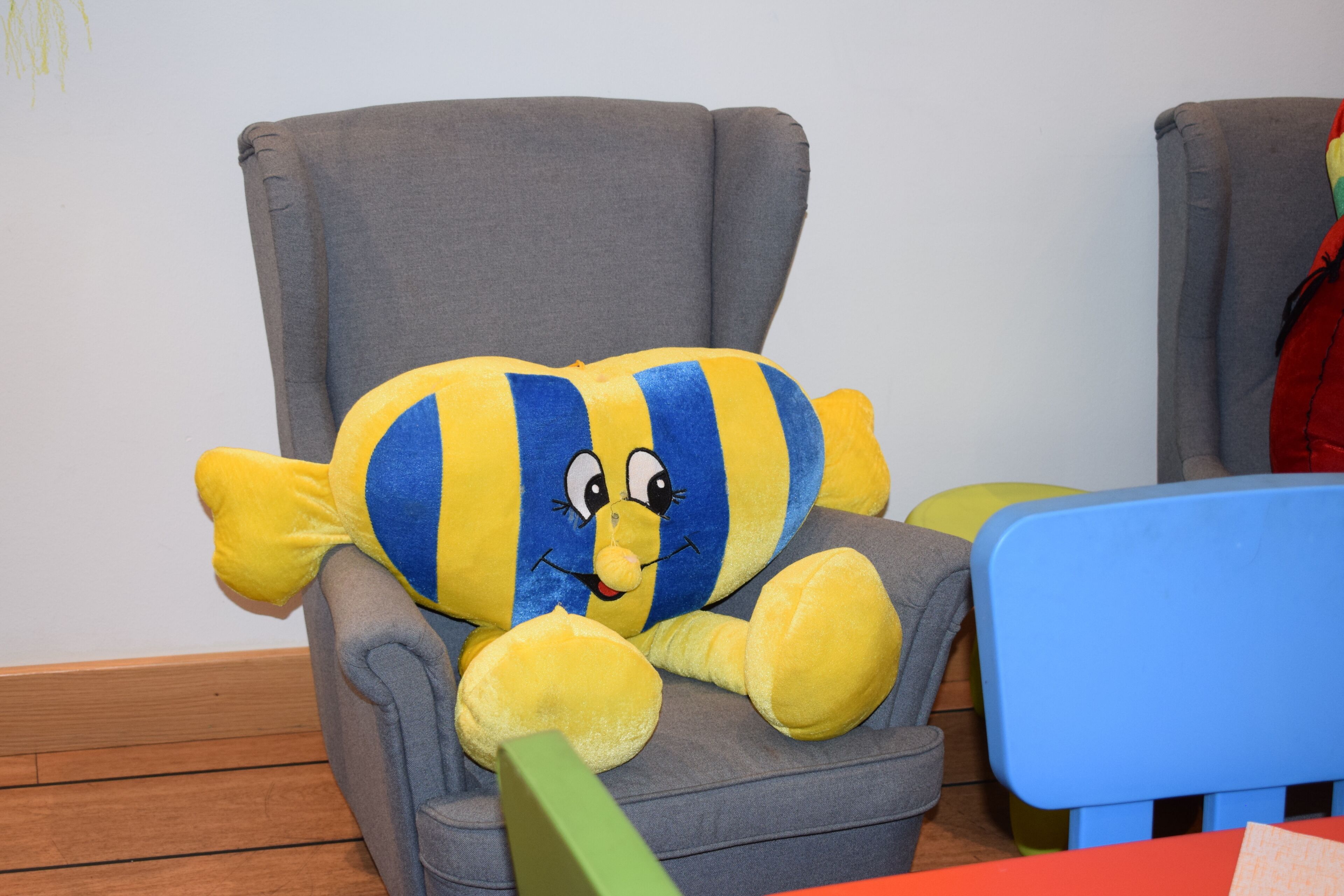 A plush toy in a grey armchair.