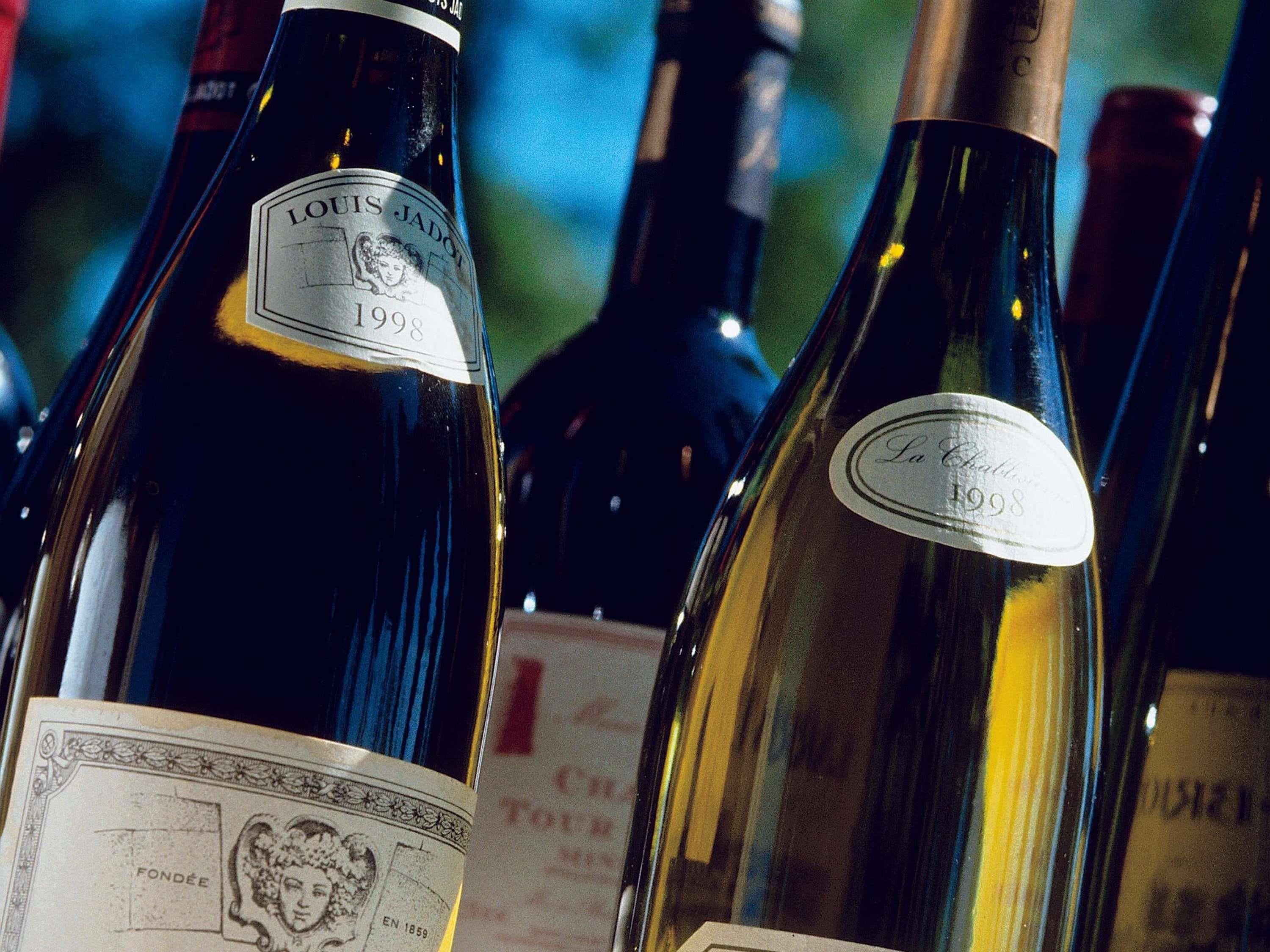 A close-up of wine bottles with labels indicating vintage years.