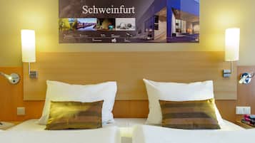 Hypo-allergenic bedding, desk, laptop workspace, blackout drapes