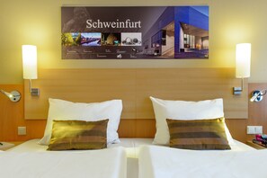 Hypo-allergenic bedding, desk, laptop workspace, blackout drapes