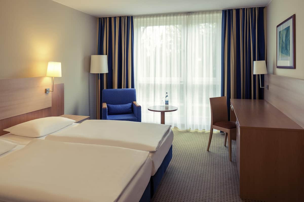 Hypo-allergenic bedding, desk, laptop workspace, blackout curtains