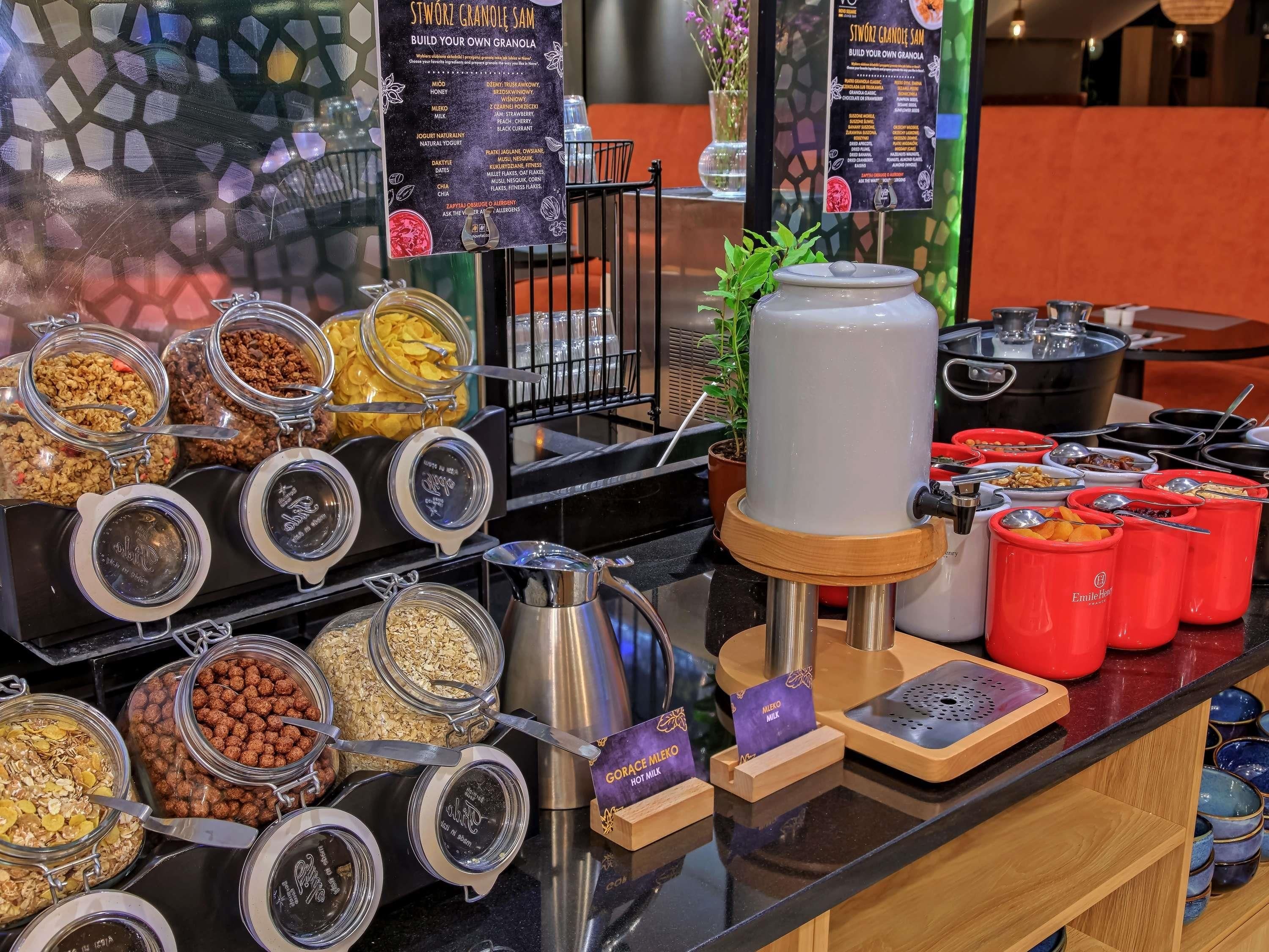 A breakfast buffet with various food items and a granola-making station.