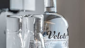 A Velote bottle and two glasses on a tray.